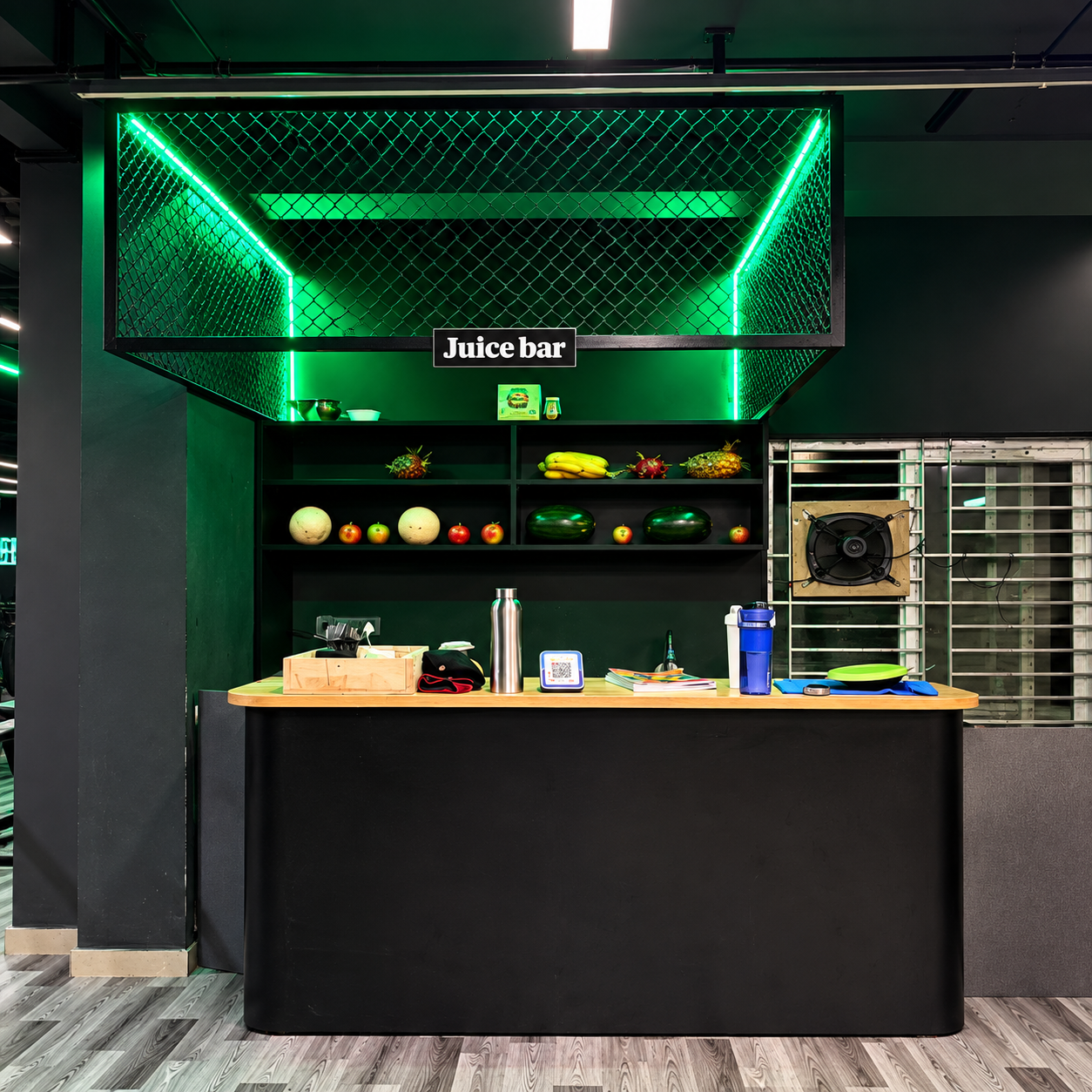 Juice bar counter with fresh fruit and green neon lighting at FIT NATION GYM in Nagasandra, Bengaluru